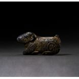 A CARVED BLACK STONE FIGURE OF A RECUMBENT RAM, PROBABLY NEAR EASTERN