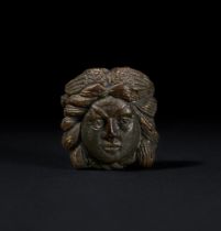 A ROMAN AMBER HEAD OF MEDUSA, CIRCA 1ST-2ND CENTURY A.D.