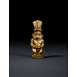 AN EGYPTIAN GOLD BES AMULET NEW KINGDOM TO THIRD INTERMEDIATE PERIOD, DYNASTY XVII-XXII