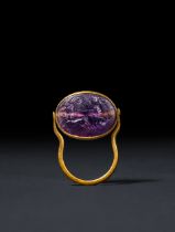 A ROMAN AMETHYST RING STONE DEPICTING CHARIOT RACING SCENE, CIRCA 2ND CENTURY A.D.