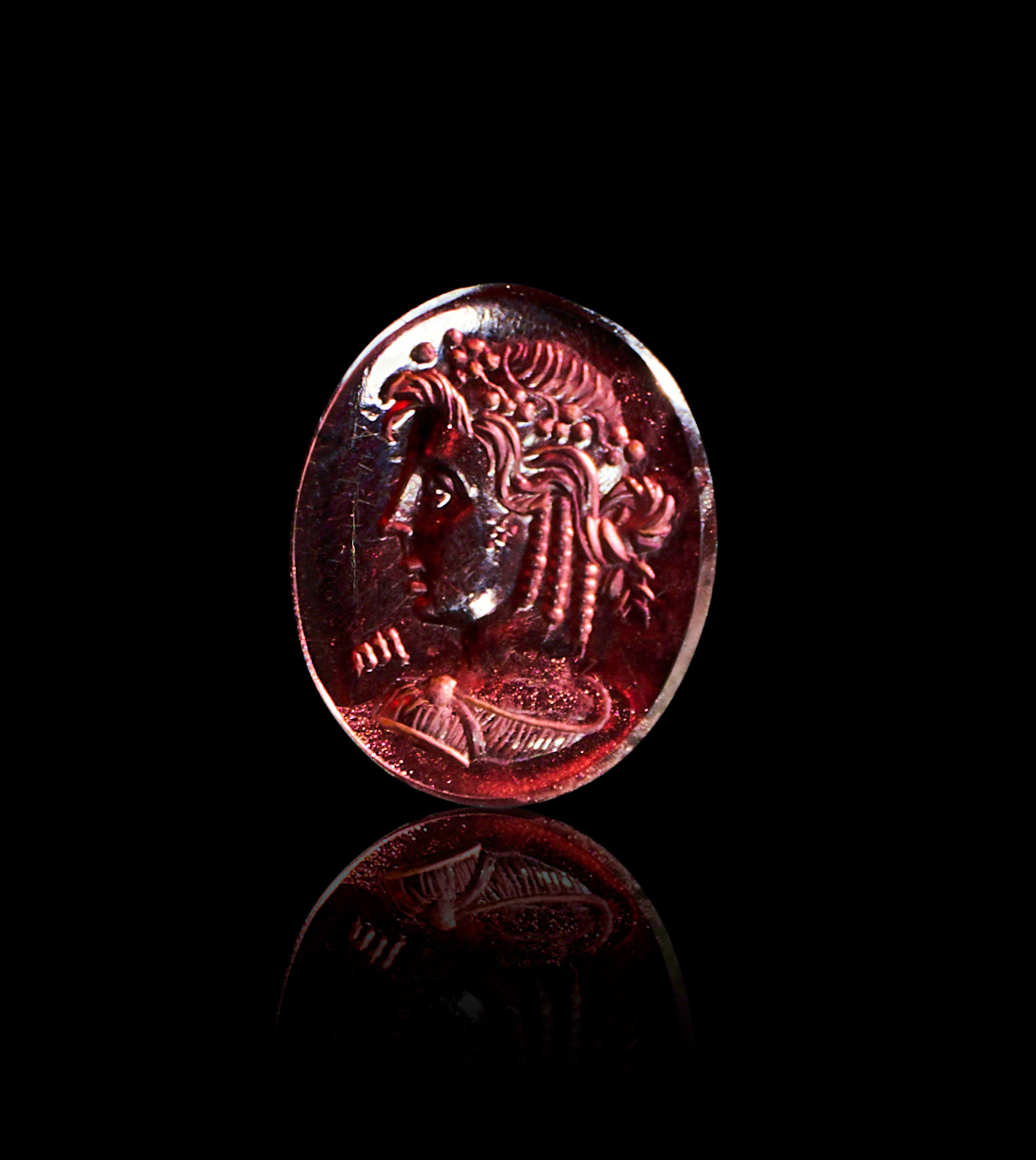 A GREEK GARNET INTAGLIO OF A GODDESS, CIRCA 4TH CENTURY A.D. OR LATER