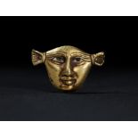 AN EGYPTIAN GOLD FACE INLAY, NEW KINGDOM, AMARNA PERIOD, DYNASTY XVIII, CIRCA 1353-1336 B.C.