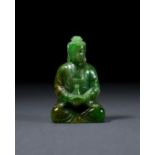 A CHINESE SPINACH JADE OF A SEATED BUDDHA, QING DYNASTY (1644-1911)