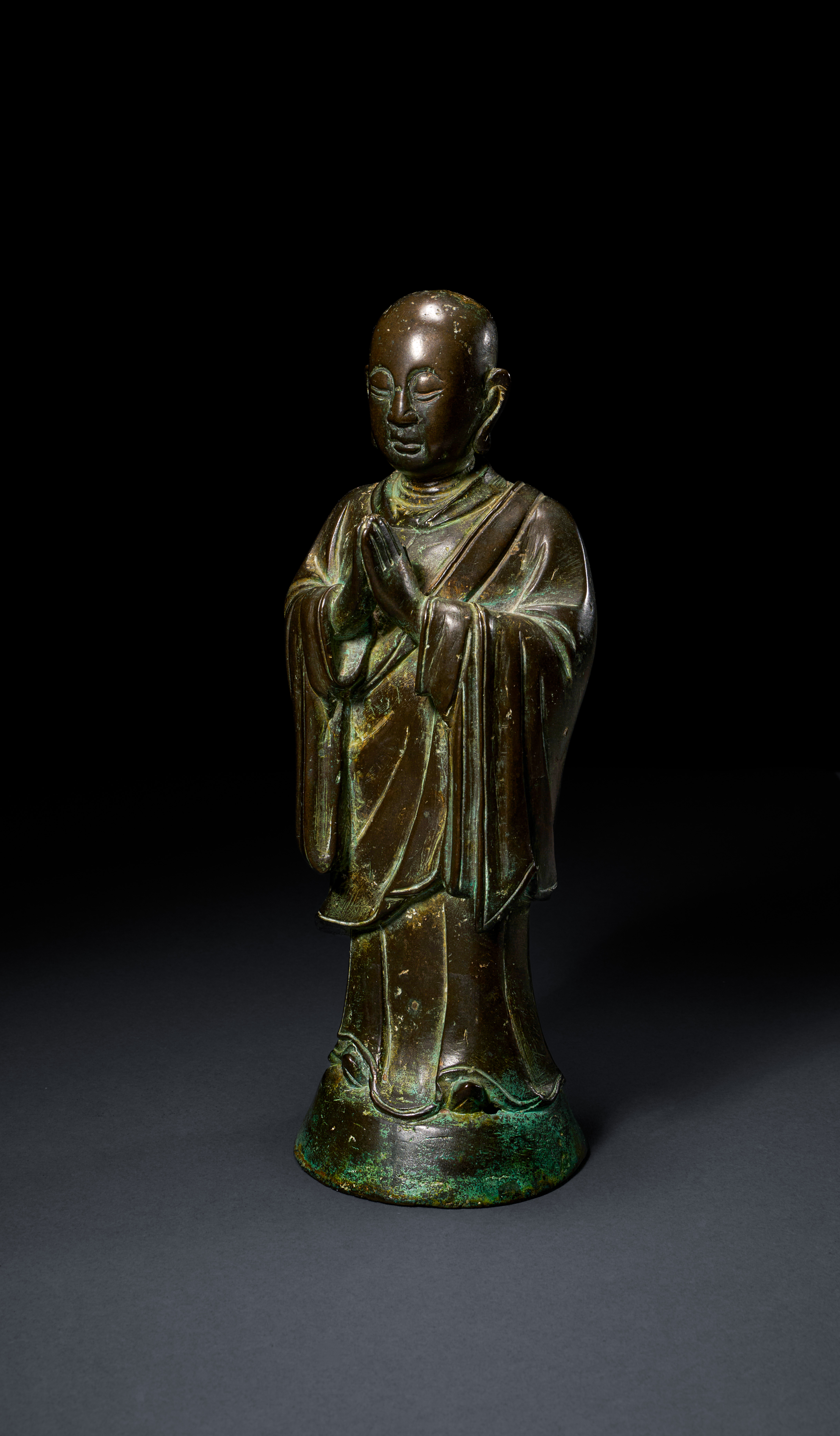 A LARGE BRONZE FIGURE OF ANANDA, MING DYNASTY (1368-1644)