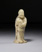 A CARVED SOAPSTONE FIGURE OF A STANDING LUOHAN, 18TH CENTURY