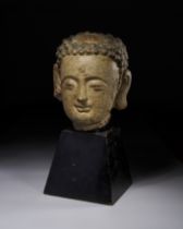 A POLYCHROME PAINTED STONE HEAD OF A BUDDHA, YUAN DYNASTY OR EARLIER