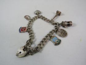 Sterling silver charm bracelet with padlock and 7 charms total weight 24.5g