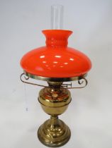 Duplex Brass & Glass Oil lamp with clear chimney and vivid Orange Glass shade. Measures 21 inches ta