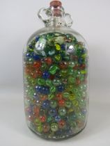 A demijohn full of various marbles.