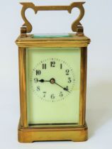 Brass Carriage Clock with enamel face. Glass panels and door. Running order, requires key. 5 inche