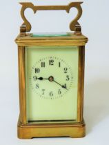 Brass Carriage Clock with enamel face. Glass panels and door.  Running order, requires key.  5 inche