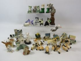 Selection of small cat and house figurines.