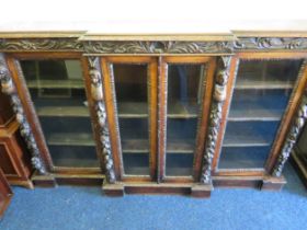 Beautifully Carved Bookcase in the Victorian Gothic Style. Glazed side doors with Glazed central dou