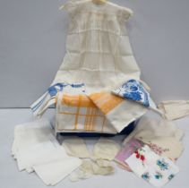 Selection of vintage table cloths, handkerchiefs, and a baby christning dress etc.