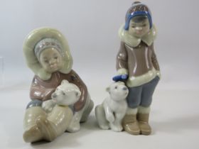 2 Lladro figurines of Eskimo boys with Polar bears. The tallest measures 15cm.