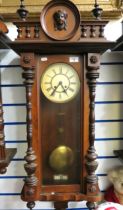 Oak Case Wall Clock with enamelled Dial. Carved Eagle to pediment. Working order with key.