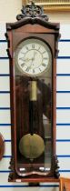 Mahogany cased wall clock with enamel dial. Single weight drive. Running order with key. Approx 42