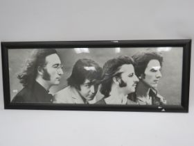 Framed Print of the Beatles which measures 39 x 14 inches. See photo