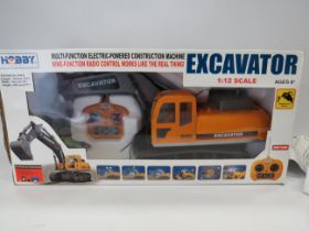Hobby Excavator in 1:12 Scale with re-chargable battery and remote control. Believed to be complete