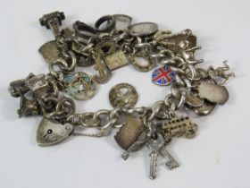 Sterling silver Charm bracelet with padlock and 21 charms total weight 71g