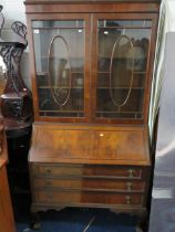 Large Mahogany Bureau/Bookcase. Two Glazed doors above with drawers under. Writing slope has tooled