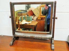 Dark Oak Tilting Dresser top mirror with carved and turned stretcher. Measures 22 x 22 inches. See p