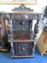 Dark Oak Court Cabinet with wonderfuly carved decoration in the Victorian Gothic Style to include Li