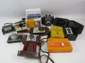 Large selection of various vintage cameras.