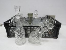 Various crystal glass decanters and drinking glasses.