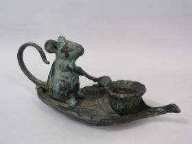 Small bronze mouse paddling a boat leaf candle holder, approx 7cm tall &17cm long.