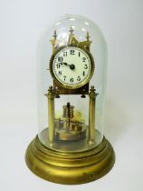 German made brass Anniversary clock under Glass dome. Appears to be in running order. Small piece m