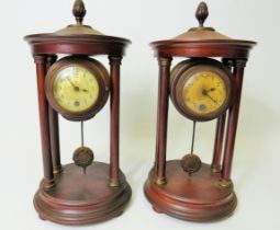 Matched pair of mantle clocks with Mahogany cases and exposed pendulums. Bun feet with Acorn final