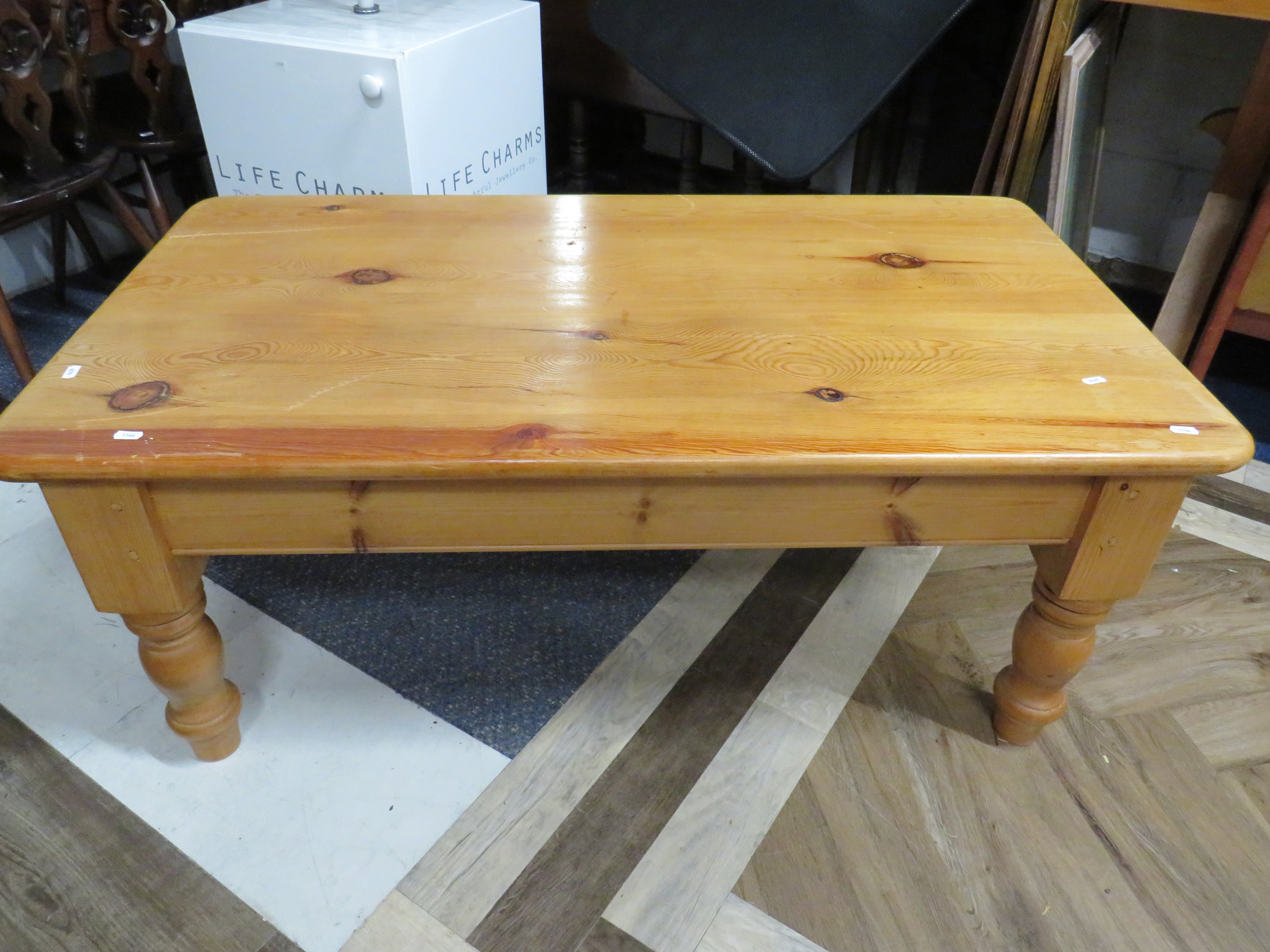 Attractive Studily built low pine table on chunky turned legs.  H:20 x W:48 x D:26 Inches. See photo