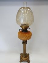 Brass and Glass Oil lamp with Corinthian style Column base and milk glass reservoir . Clear glass c