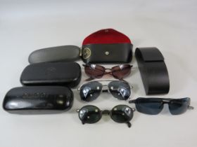 Various Sunglasses Prada, Ray-ban, Storm and Armani plus a few empty cases.