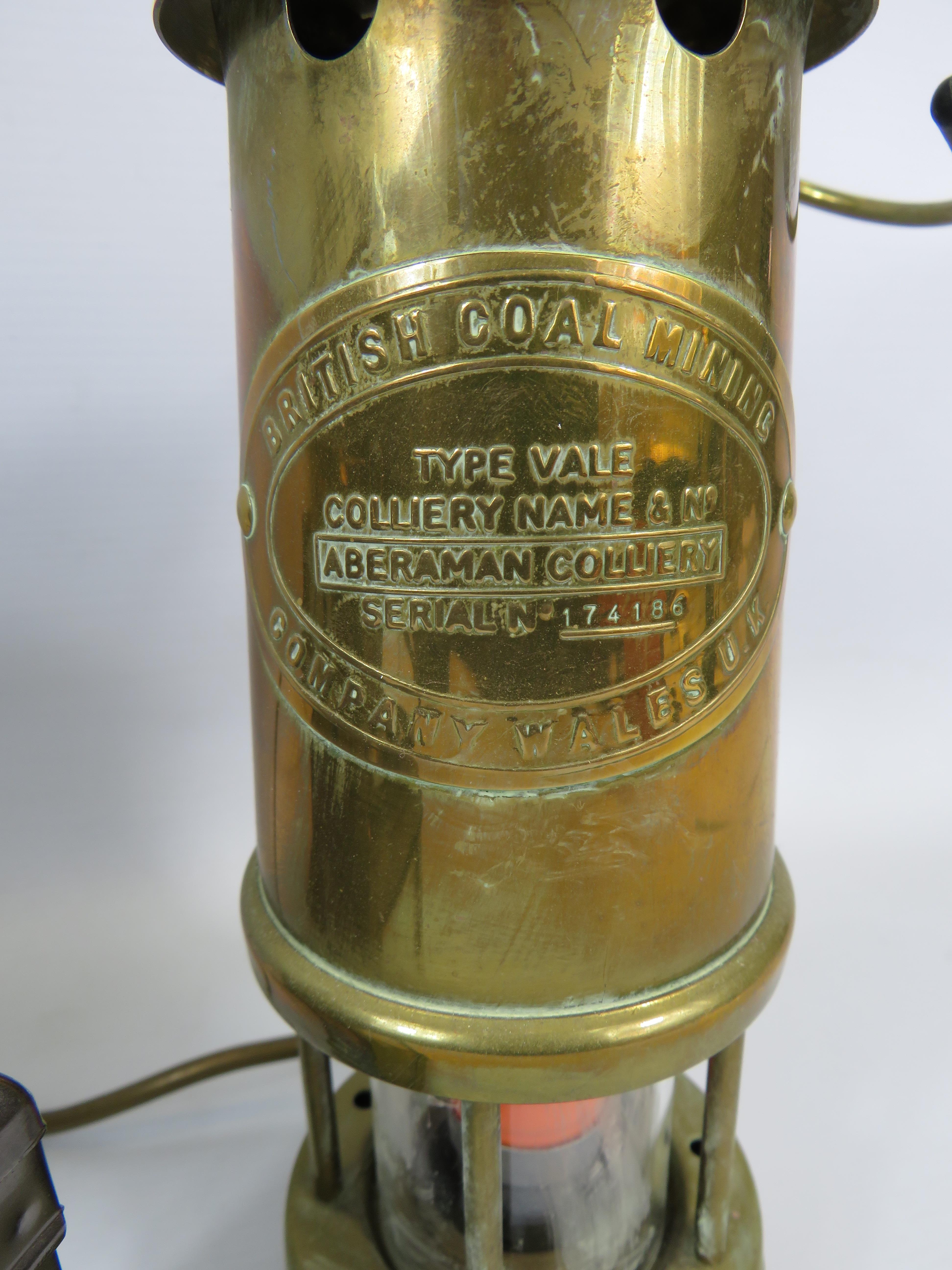 British Coal Mining Type Vale converted to electric lamp, a brass storm lantern and a tea light - Image 2 of 3