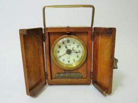 Small German made Carriage Alarm clock in running order. 4 inches tall. Requires key. See photos.