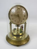 Small Bentima Brass based Anniversary clock under a glass dome. Running order. No key present. Measu