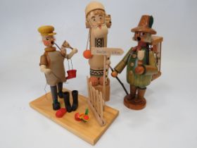 Three German made wooden novelty toys, Smoking shoe seller, Smoking flute model plus one other figu