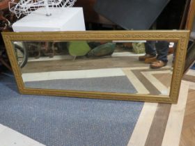 Large Bevelled Glass mirror with wall fixing lugs and attractive carved gilt frame. Measures 24 x 56