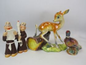 Kitch ceramic figurines including a large lustre Deer, one monk has had a repair to the candle.