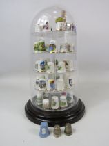 53 Thimbles including 2 which are sterling silver in a display dome.