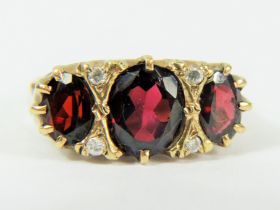 9ct Yellow Gold Gypsy Style Ring set with a Large Central Oval Garnet which measures approx 10 x 8 m