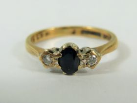 9ct Yellow Gold ring set with a Central Sapphire and flanked by two Melee Diamonds. Finger size 'J'