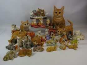 Large selection of resin cat figurines.