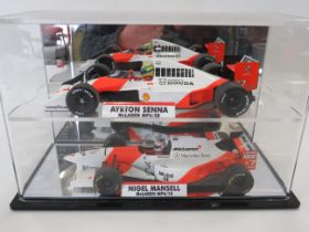 Two Die Cast Models of F1 Mclarens in the Nigel Mansell and Ayrton Senna Liveries. Both housed in a