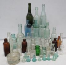 Selection of vintage glass bottles including Advertising and Medical.