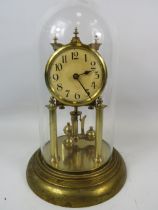 German Made Brass based Anniversary clock with enamel Dial. Sits under a Glass dome which measures a