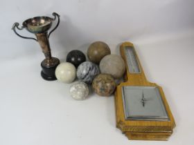 Mixed lot to include a barometer and thermometer, Silver plated trophy and 7 polished stone balls.