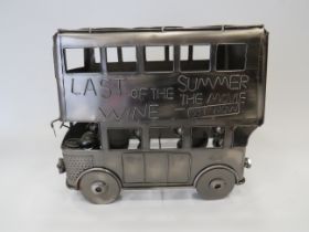 Metal Six bottle wine rack shaped as an open topped bus. Measures approx 12 inches x 14 inches. See